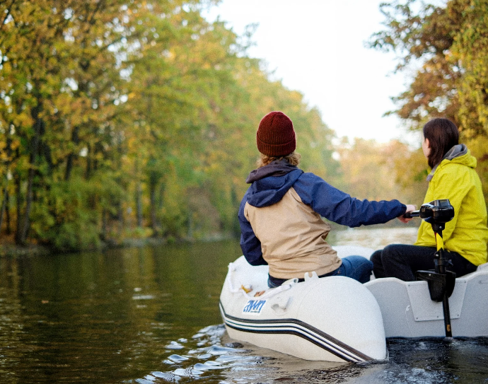 Two anglers fishing from a raft powered by a Bronson lithium trolling motor battery